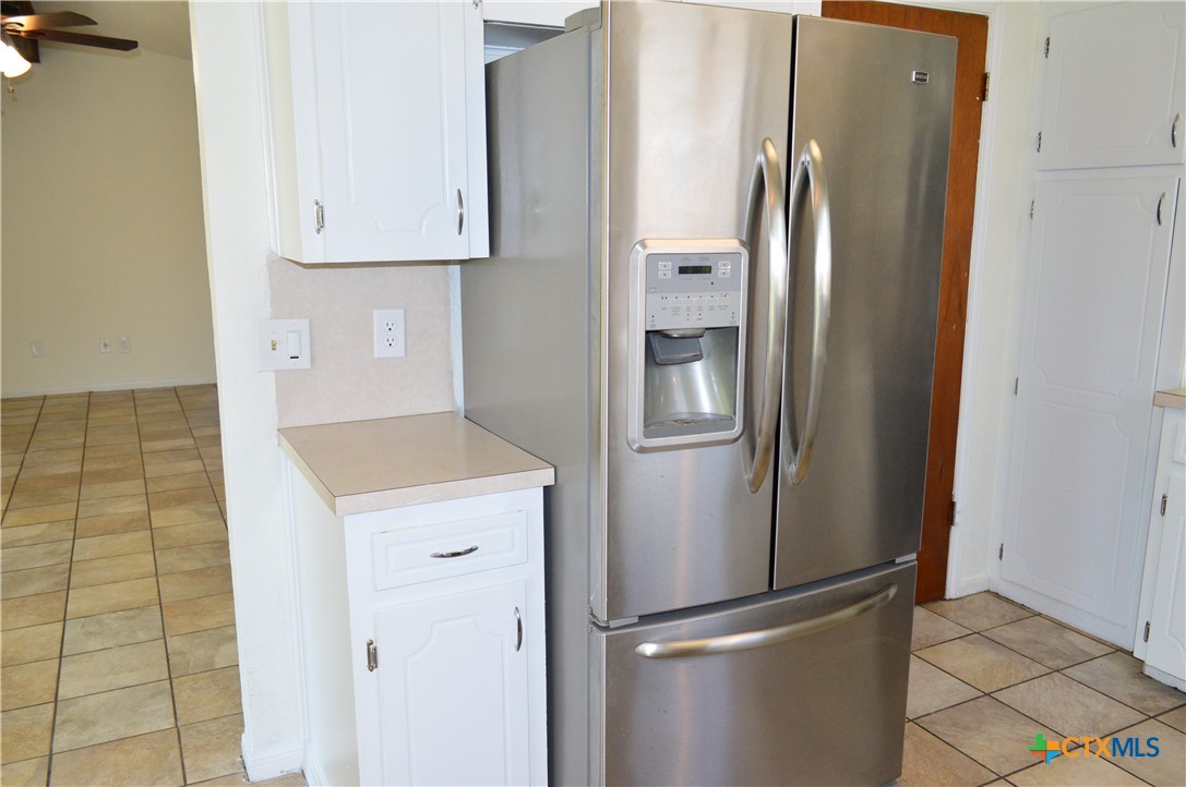 1404 Rob Lane Copperas Cove, TX 76522 - Photo 15 of 31 a view of a refrigerator in kitchen and an empty room
