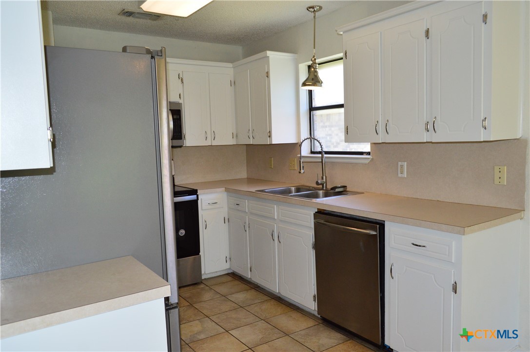 1404 Rob Lane Copperas Cove, TX 76522 - Photo 16 of 31 a kitchen with a white cabinets and window