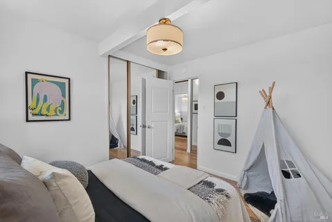 a bedroom with a bed and a mirror