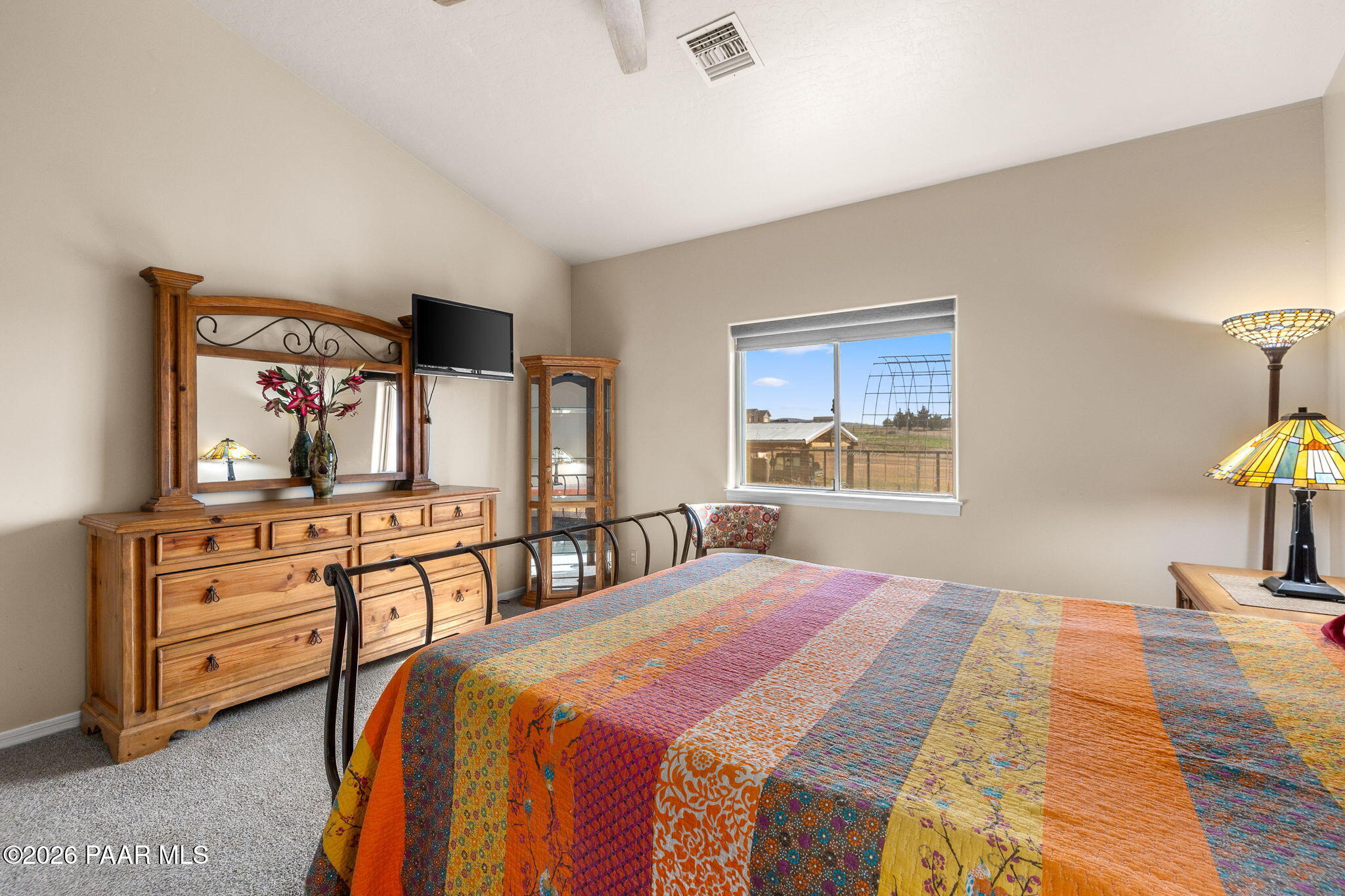 26455 North Bull Snake Road Paulden, AZ 86334 - Photo 14 of 40 a bedroom with a bed and a lamp on dresser