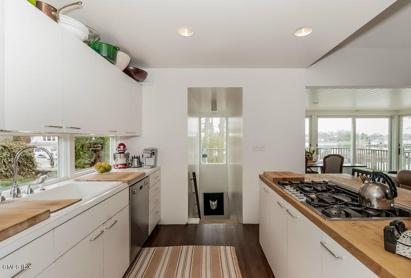 25 Willowmere Avenue Riverside, CT 06878 - Photo 13 of 24 a kitchen with a sink stove and refrigerator