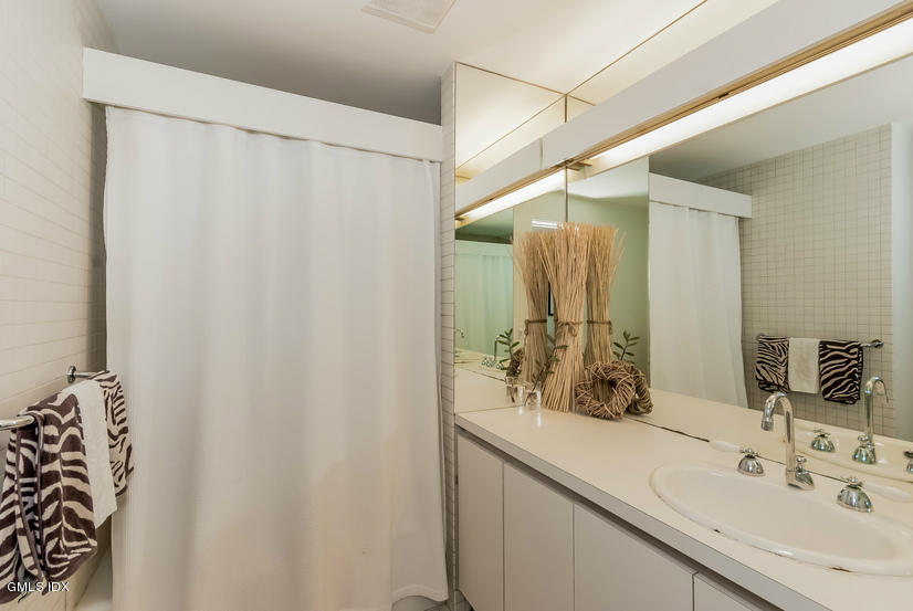 25 Willowmere Avenue Riverside, CT 06878 - Photo 16 of 24 a bathroom with a sink and a mirror