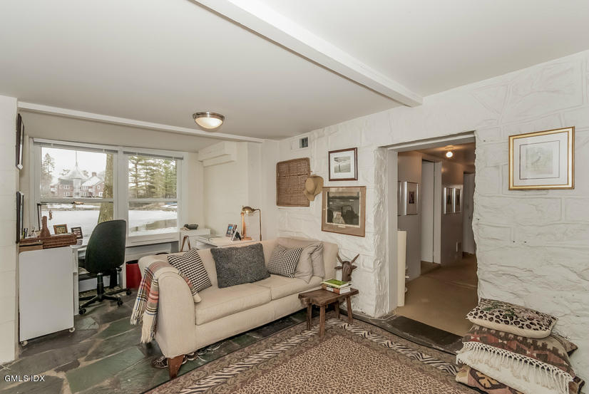 25 Willowmere Avenue Riverside, CT 06878 - Photo 17 of 24 a living room with furniture and a floor to ceiling window