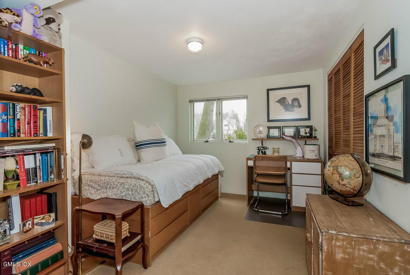 25 Willowmere Avenue Riverside, CT 06878 - Photo 20 of 24 a bedroom with a bed and a book shelf