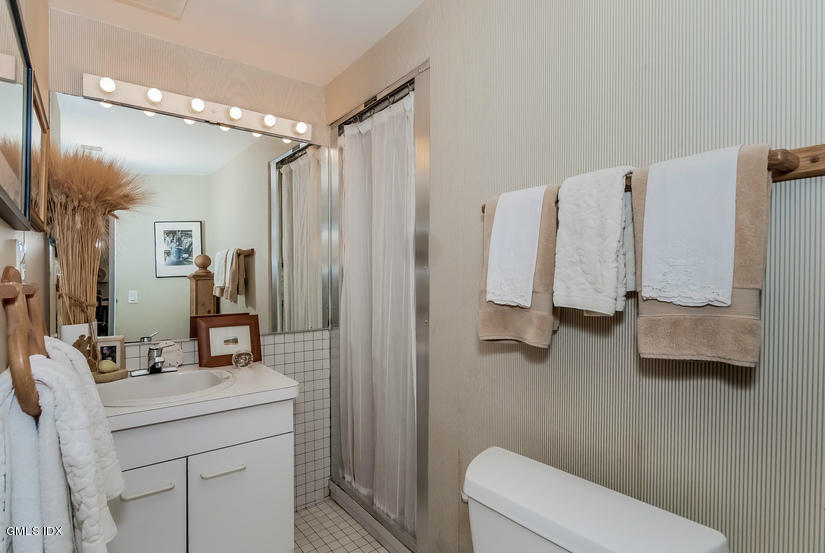 25 Willowmere Avenue Riverside, CT 06878 - Photo 21 of 24 a bathroom with a double vanity sink and mirror