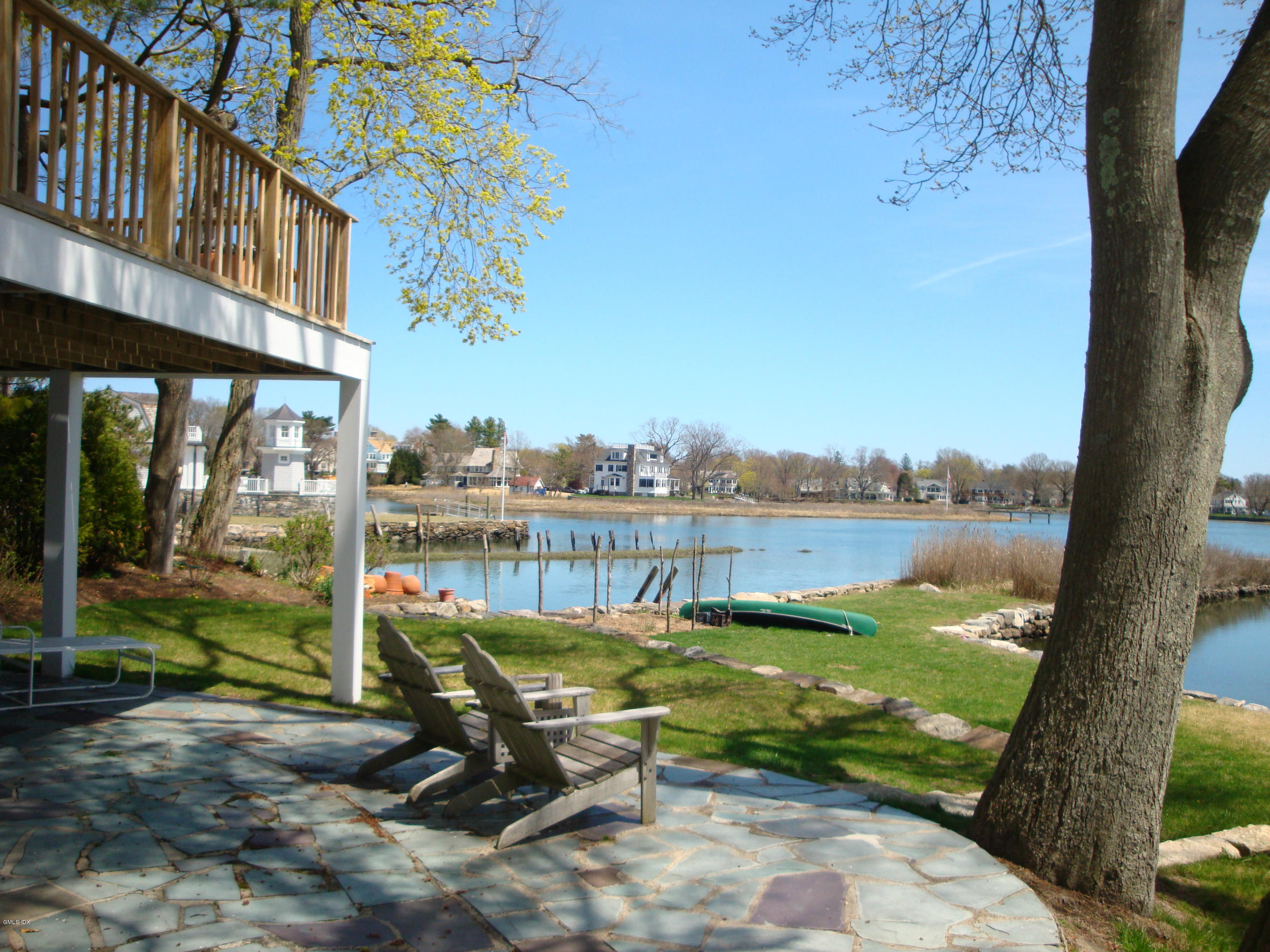 25 Willowmere Avenue Riverside, CT 06878 - Photo 22 of 24 a view of a lake with a bench and floor to ceiling window