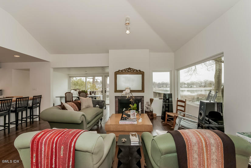 25 Willowmere Avenue Riverside, CT 06878 - Photo 7 of 24 a living room with furniture fireplace and large windows