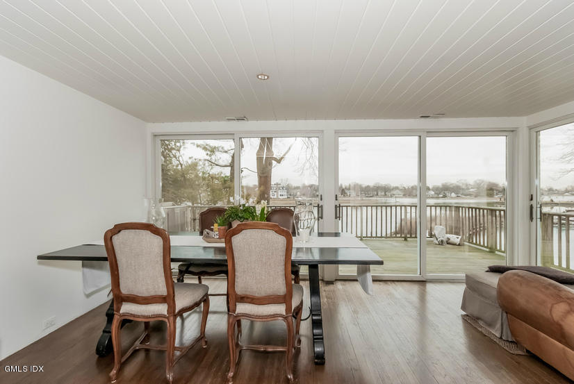 25 Willowmere Avenue Riverside, CT 06878 - Photo 9 of 24 a living room with furniture and a floor to ceiling window
