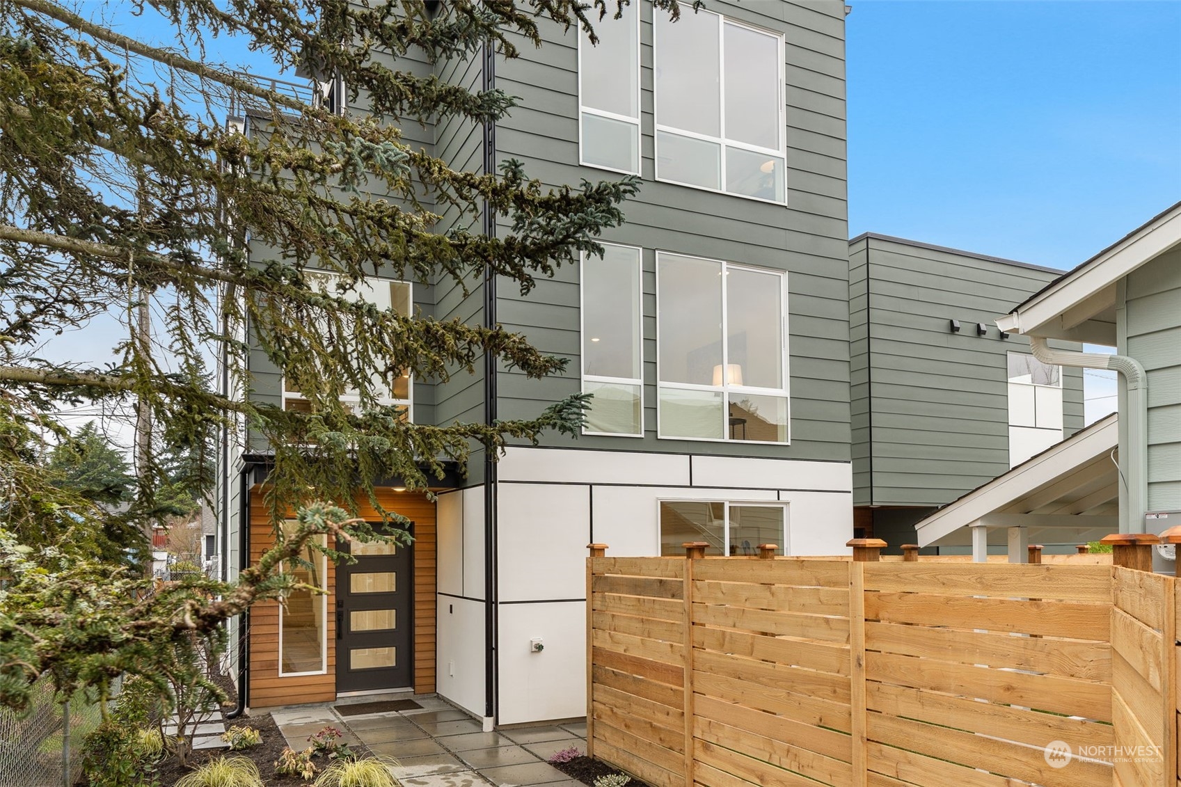 8849 30th Avenue Southwest Seattle, WA 98126 - Photo 1 of 37 front view of a house with large trees