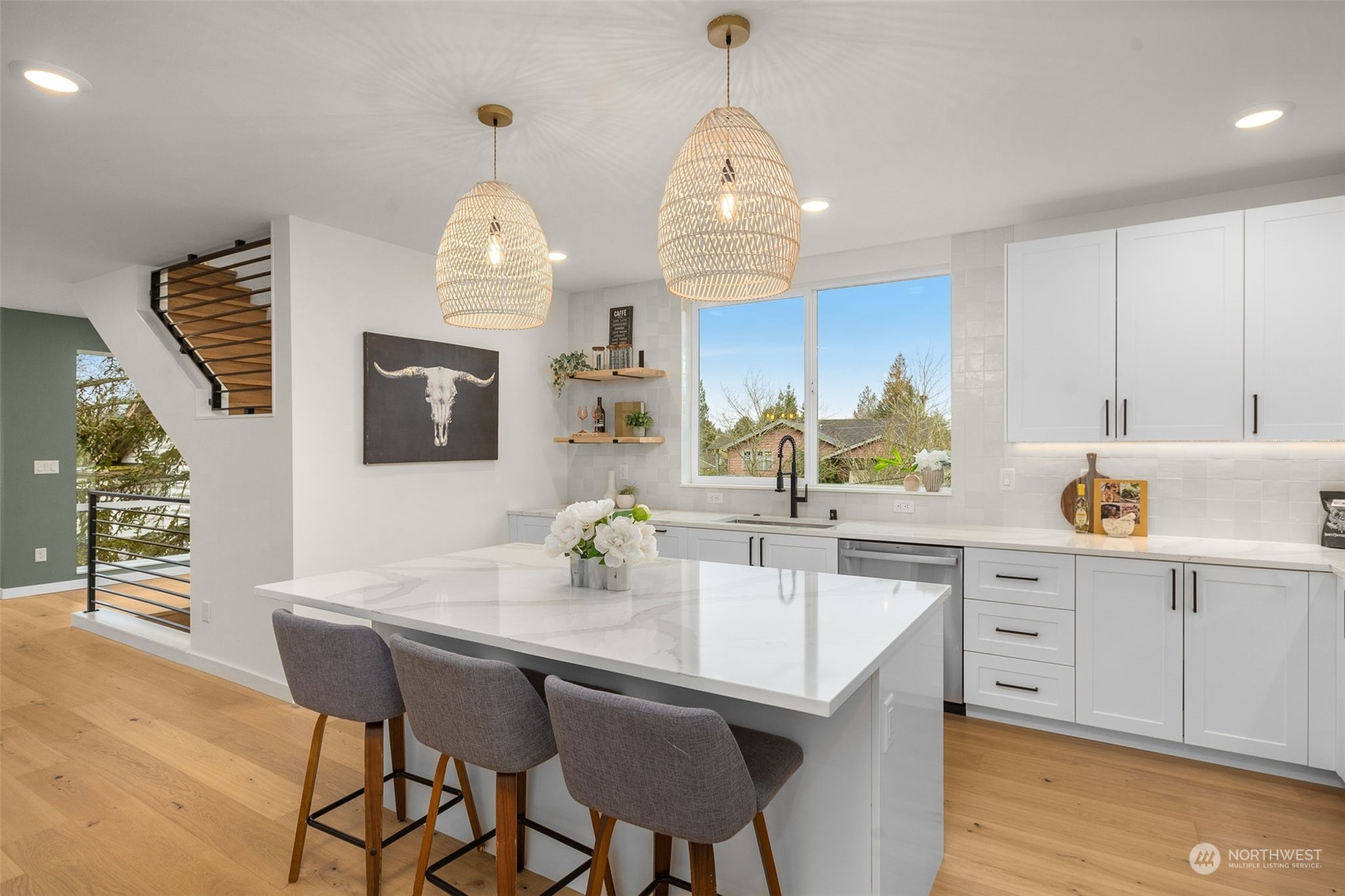 8849 30th Avenue Southwest Seattle, WA 98126 - Photo 12 of 37 a kitchen with a dining table chairs sink and cabinets