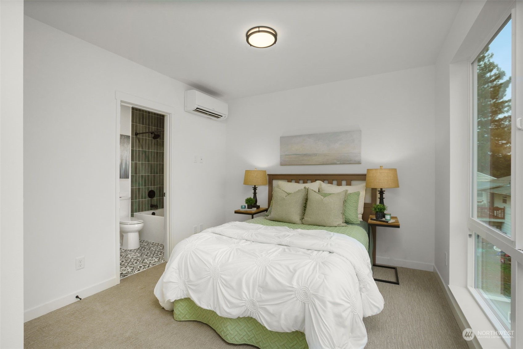 8849 30th Avenue Southwest Seattle, WA 98126 - Photo 23 of 37 a bed sitting in a bedroom next to a window