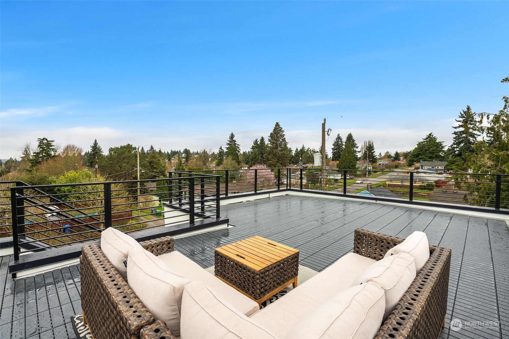 8849 30th Avenue Southwest Seattle, WA 98126 - Photo 31 of 37 a view of a roof deck with couches and wooden floor