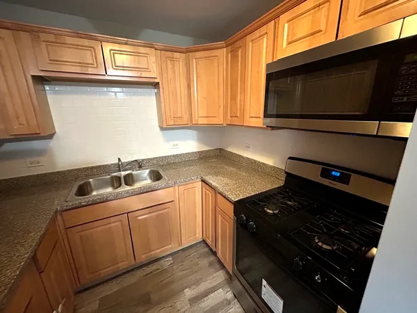 a kitchen with a stove microwave and sink