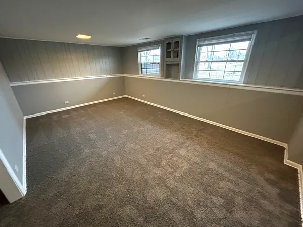 an empty room with a empty space and windows