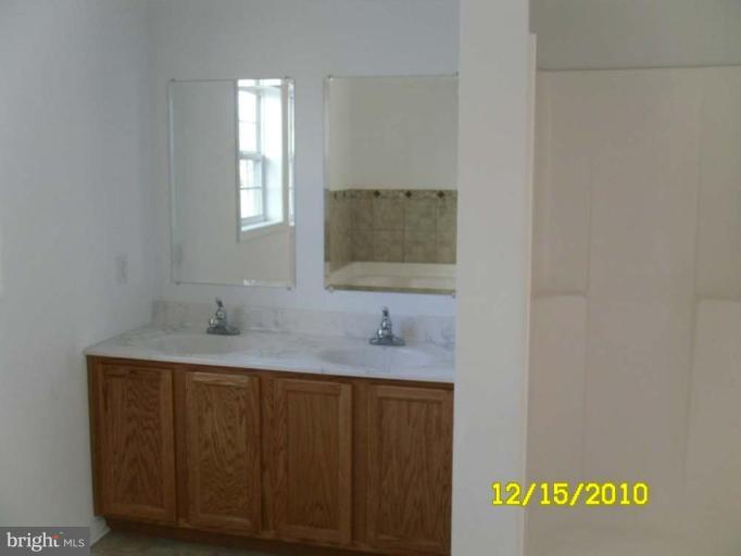 1311 Sulphur Spring Road Halethorpe, MD 21227 - Photo 3 of 16 a bathroom with a granite countertop sink and a mirror