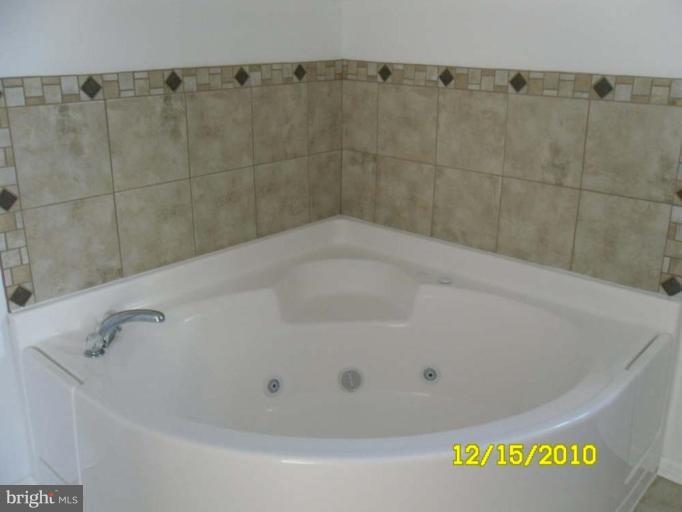 1311 Sulphur Spring Road Halethorpe, MD 21227 - Photo 4 of 16 a close up of a bathtub in a bathroom