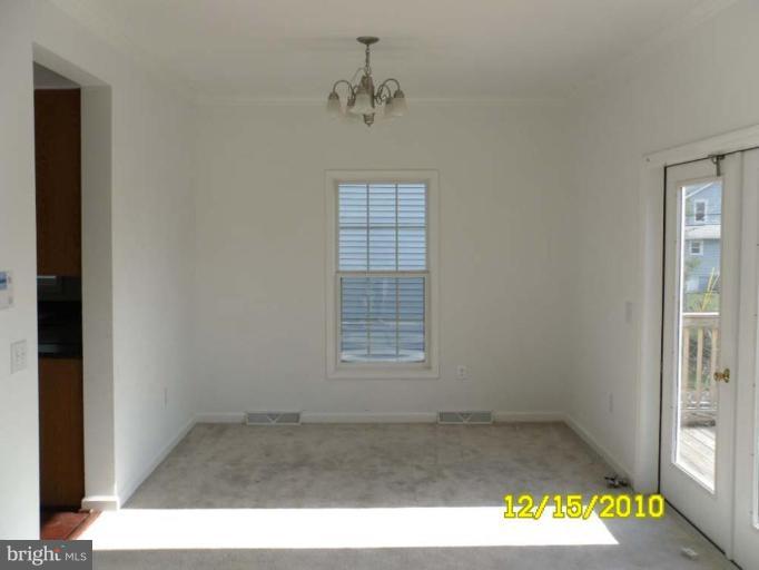 1311 Sulphur Spring Road Halethorpe, MD 21227 - Photo 10 of 16 an empty room with a window and a ceiling fan