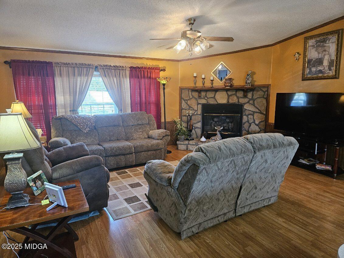 163 Spring Valley Drive Byron, GA 31008 - Photo 3 of 62 a living room with furniture a fireplace and a flat screen tv