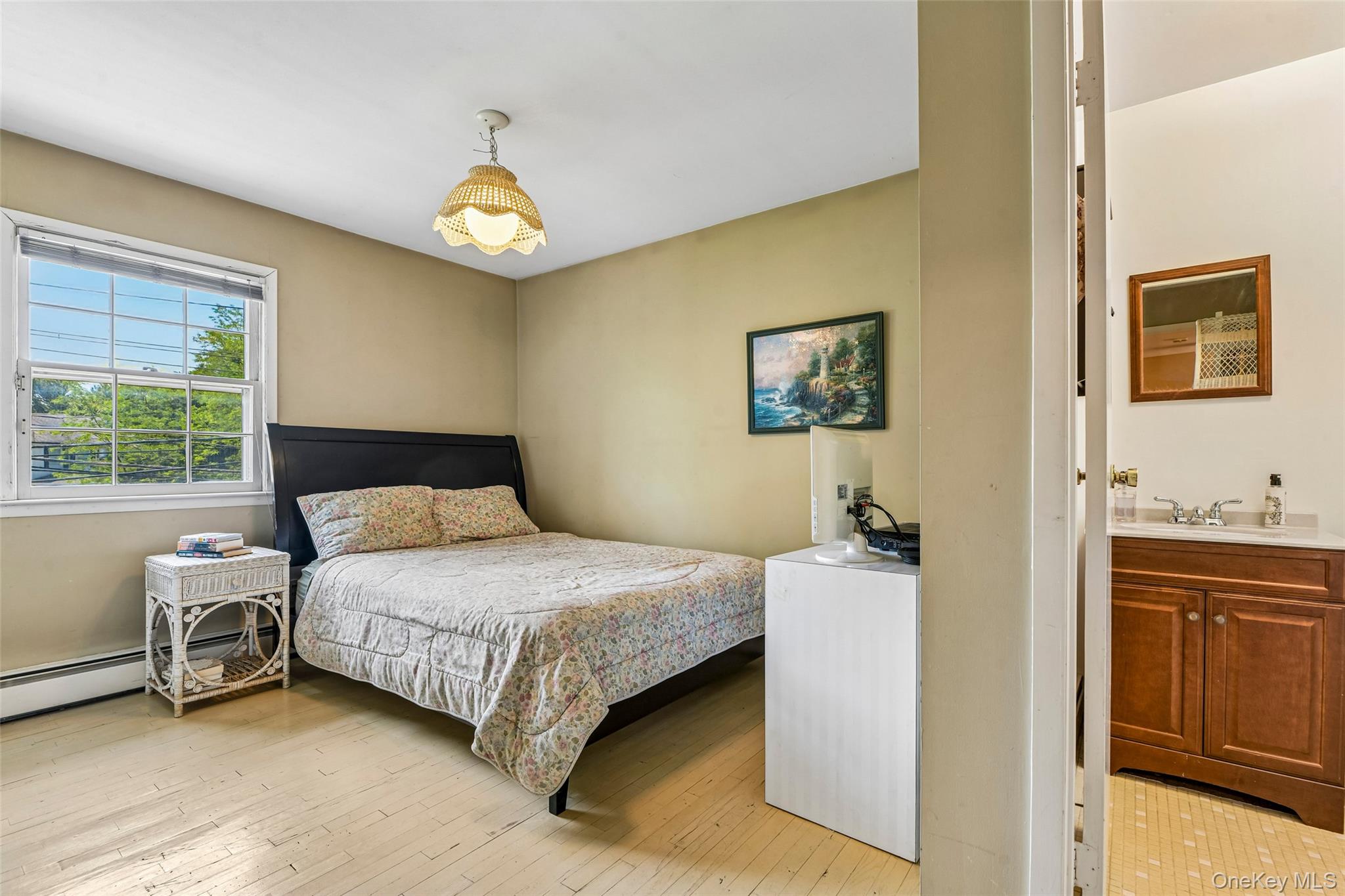 100 Hewlett Neck Road Woodmere, NY 11598 - Photo 31 of 45 a bedroom with a bed and a chandelier