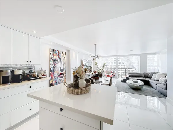 a kitchen with a sink white cabinets and stainless steel appliances