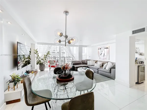 a living room with furniture and a chandelier