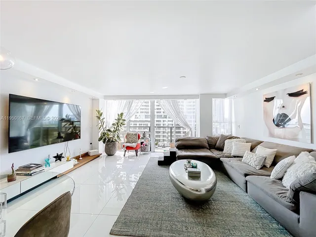 a living room with furniture and a large window with garden view