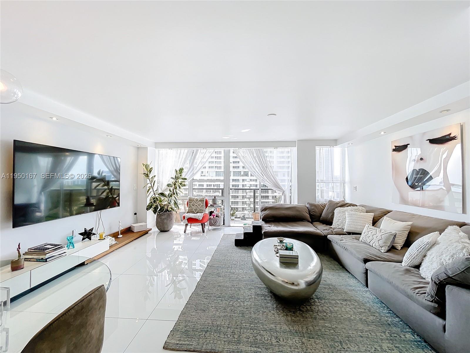 600 Northeast 36th Street, Unit 703 Miami, FL 33137 - Photo 18 of 48 a living room with furniture and a flat screen tv