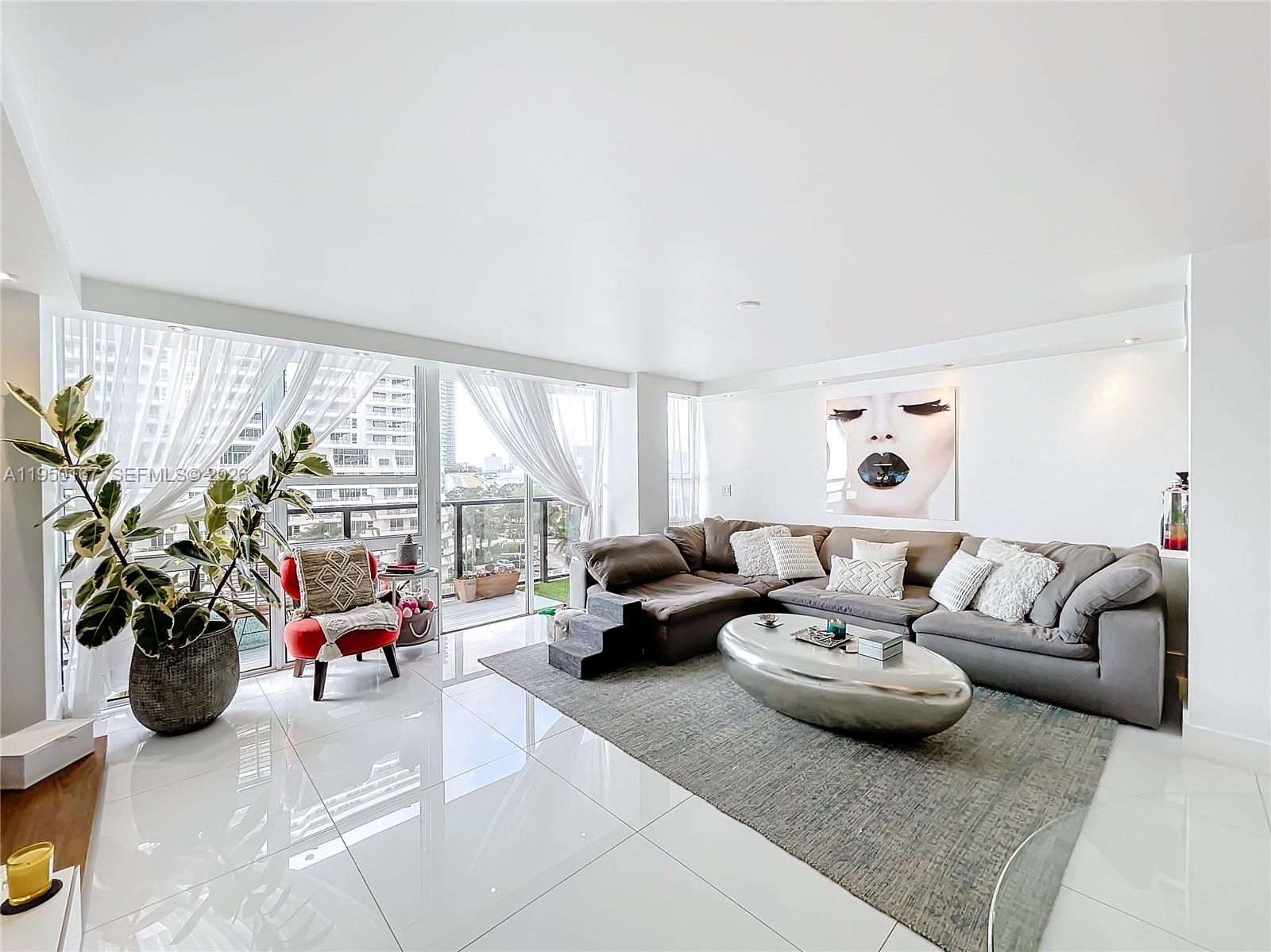 600 Northeast 36th Street, Unit 703 Miami, FL 33137 - Photo 19 of 48 a living room with furniture and a large window with garden view