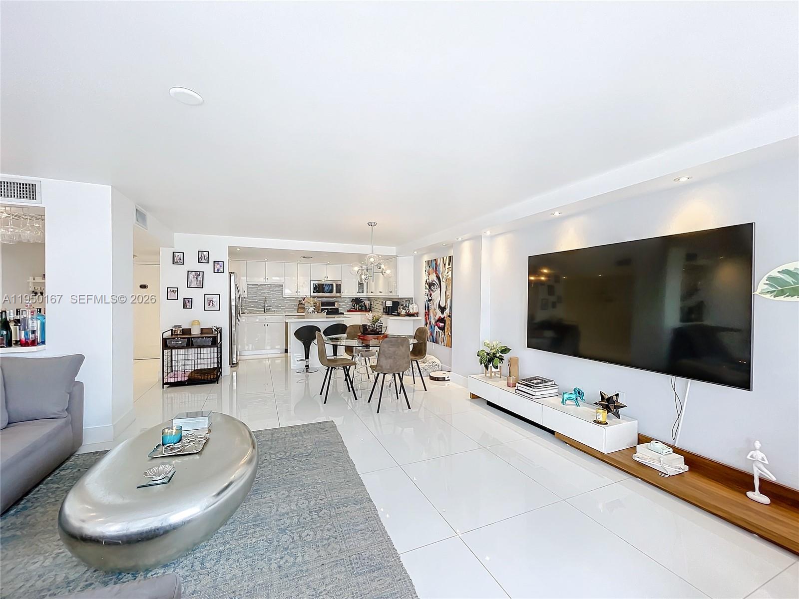 600 Northeast 36th Street, Unit 703 Miami, FL 33137 - Photo 21 of 48 a living room with furniture and a flat screen tv