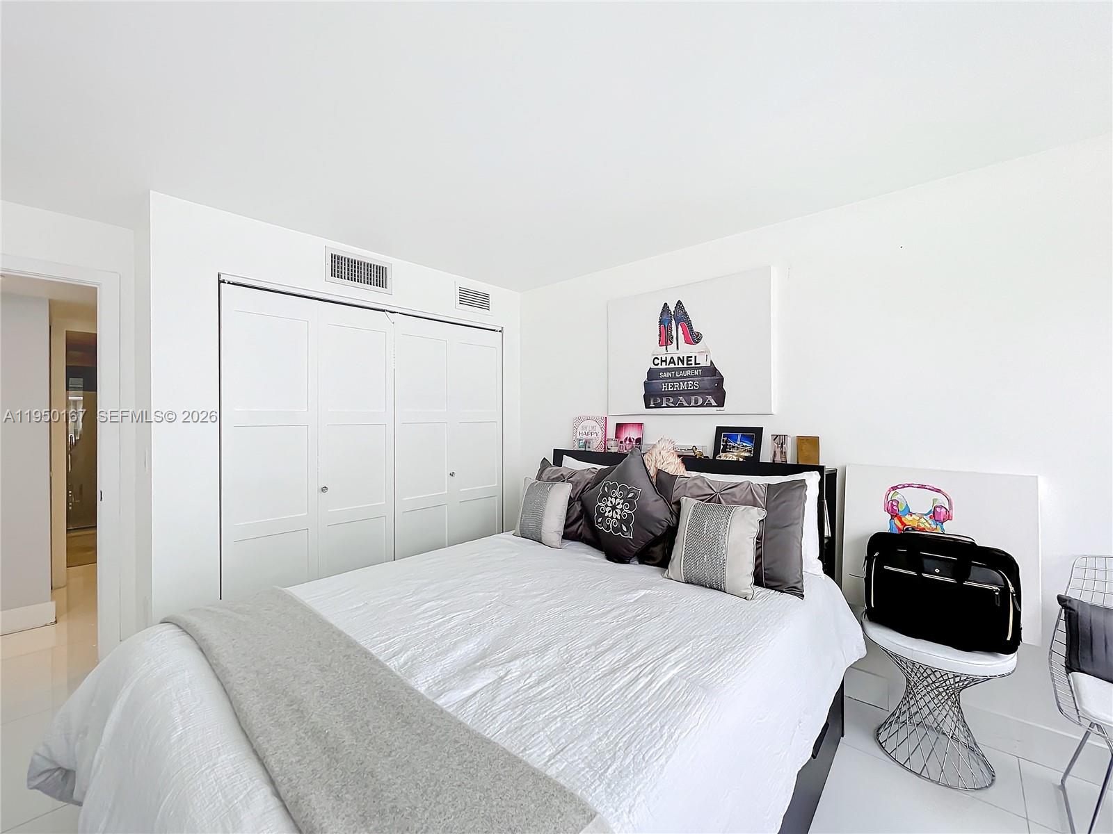 600 Northeast 36th Street, Unit 703 Miami, FL 33137 - Photo 24 of 48 a bedroom with a bed and a closet
