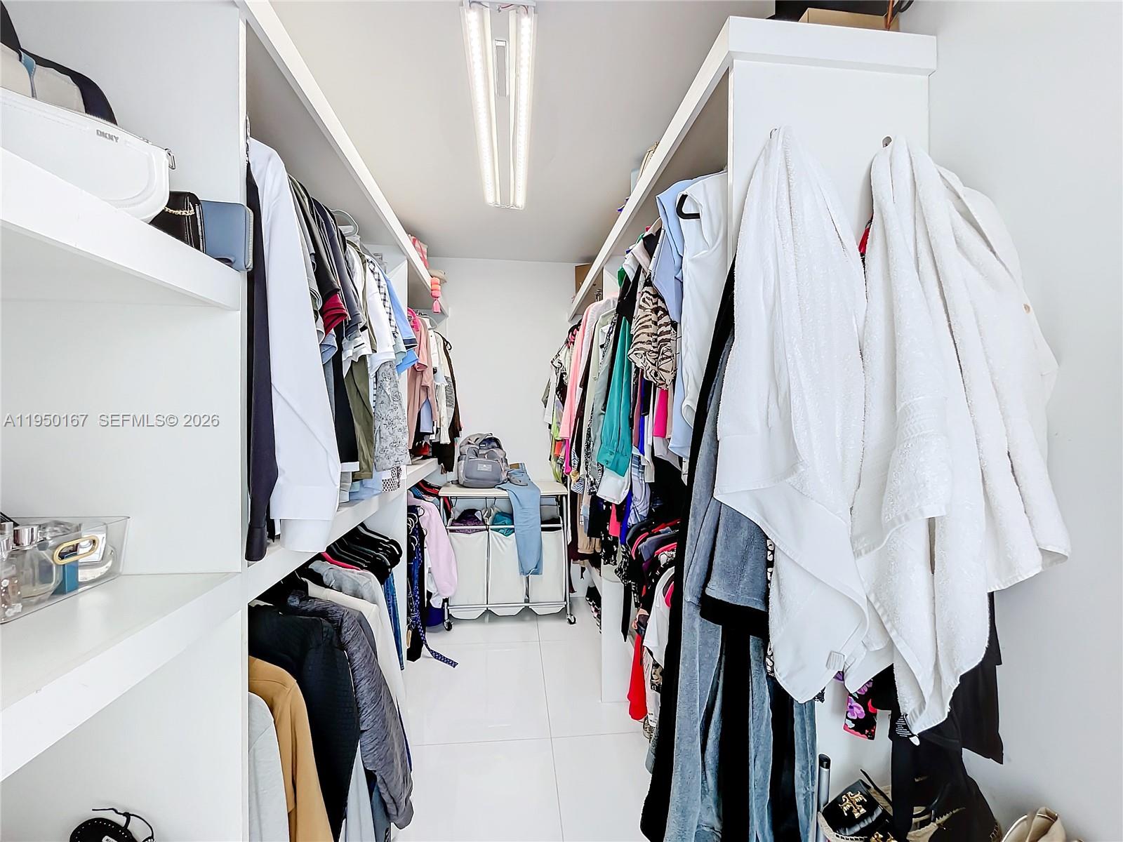 600 Northeast 36th Street, Unit 703 Miami, FL 33137 - Photo 27 of 48 a view of walk in closet with clothes and shoes