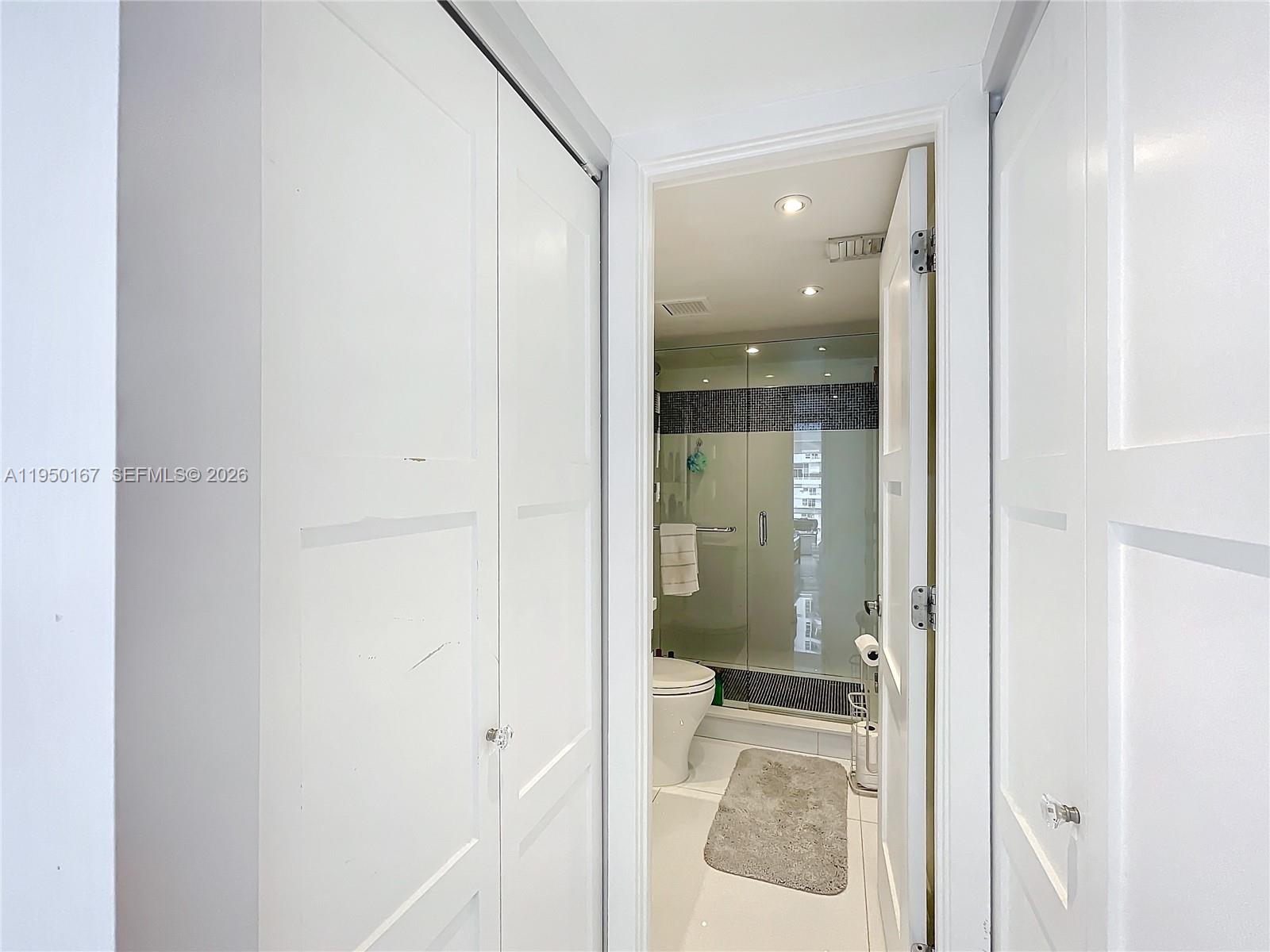600 Northeast 36th Street, Unit 703 Miami, FL 33137 - Photo 29 of 48 a bathroom with a glass shower door