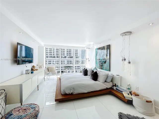 a bedroom with a bed and a large window