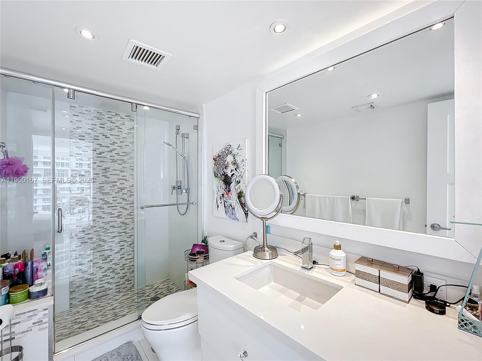 600 Northeast 36th Street, Unit 703 Miami, FL 33137 - Photo 36 of 48 a bathroom with a sink vanity granite toilet and shower