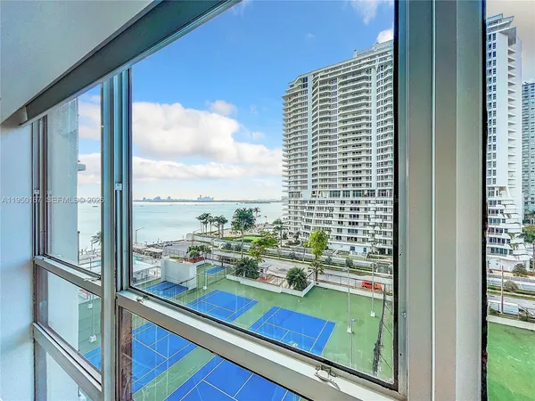 a city view from a balcony with outdoor seating