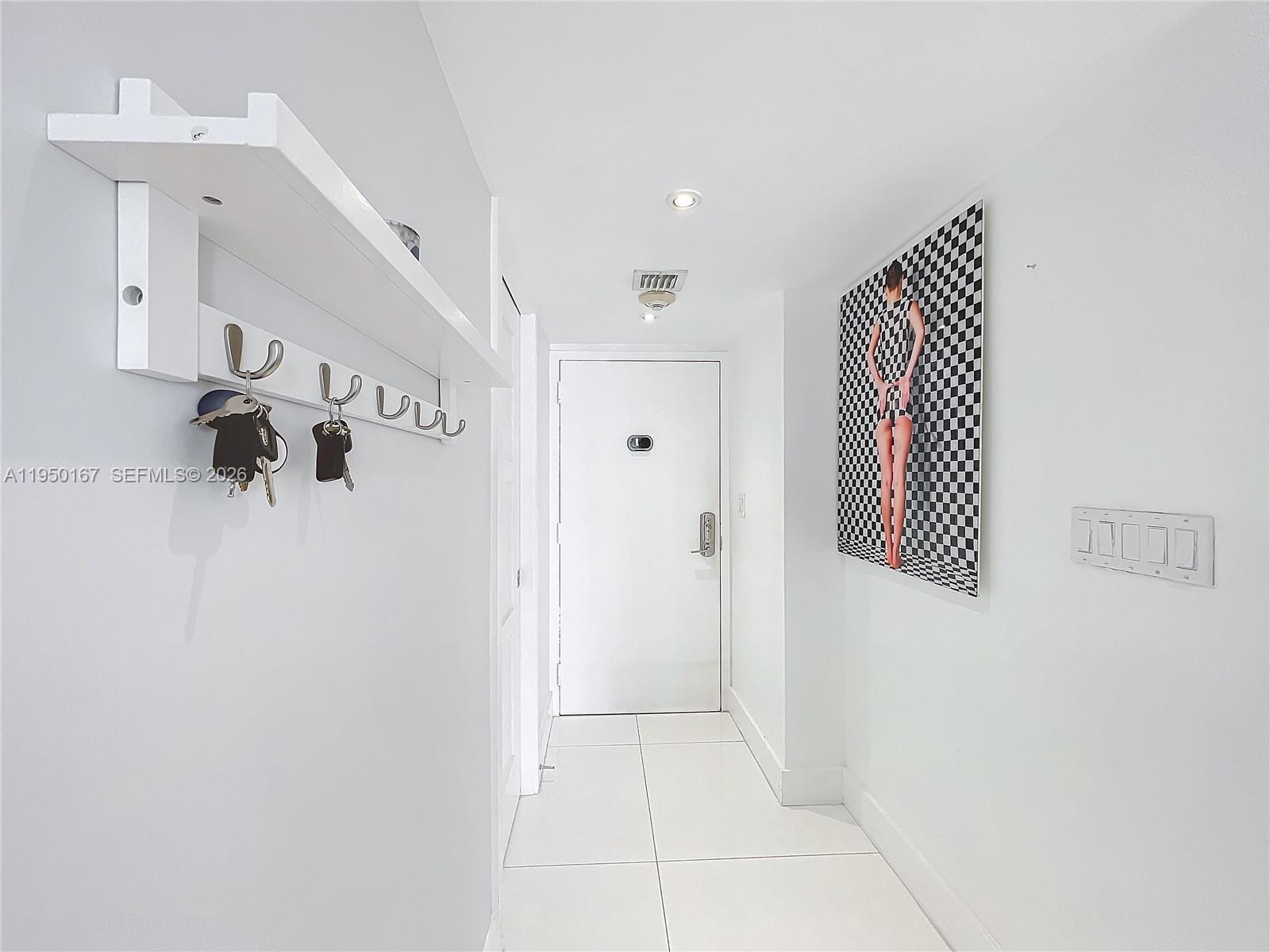 600 Northeast 36th Street, Unit 703 Miami, FL 33137 - Photo 6 of 48 a view of room with a white wall and a shower