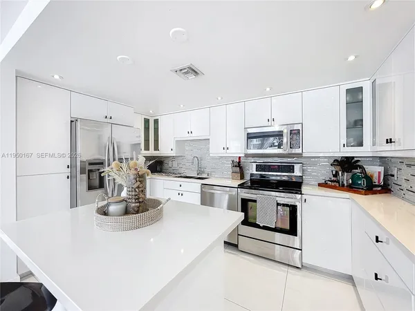 a kitchen with a stove and a refrigerator