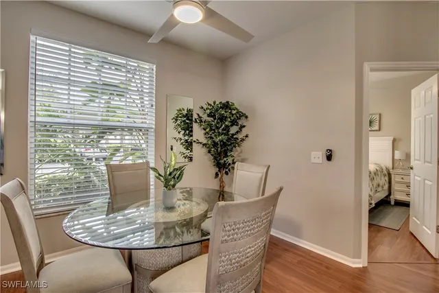 a dining room with furniture and wooden floor