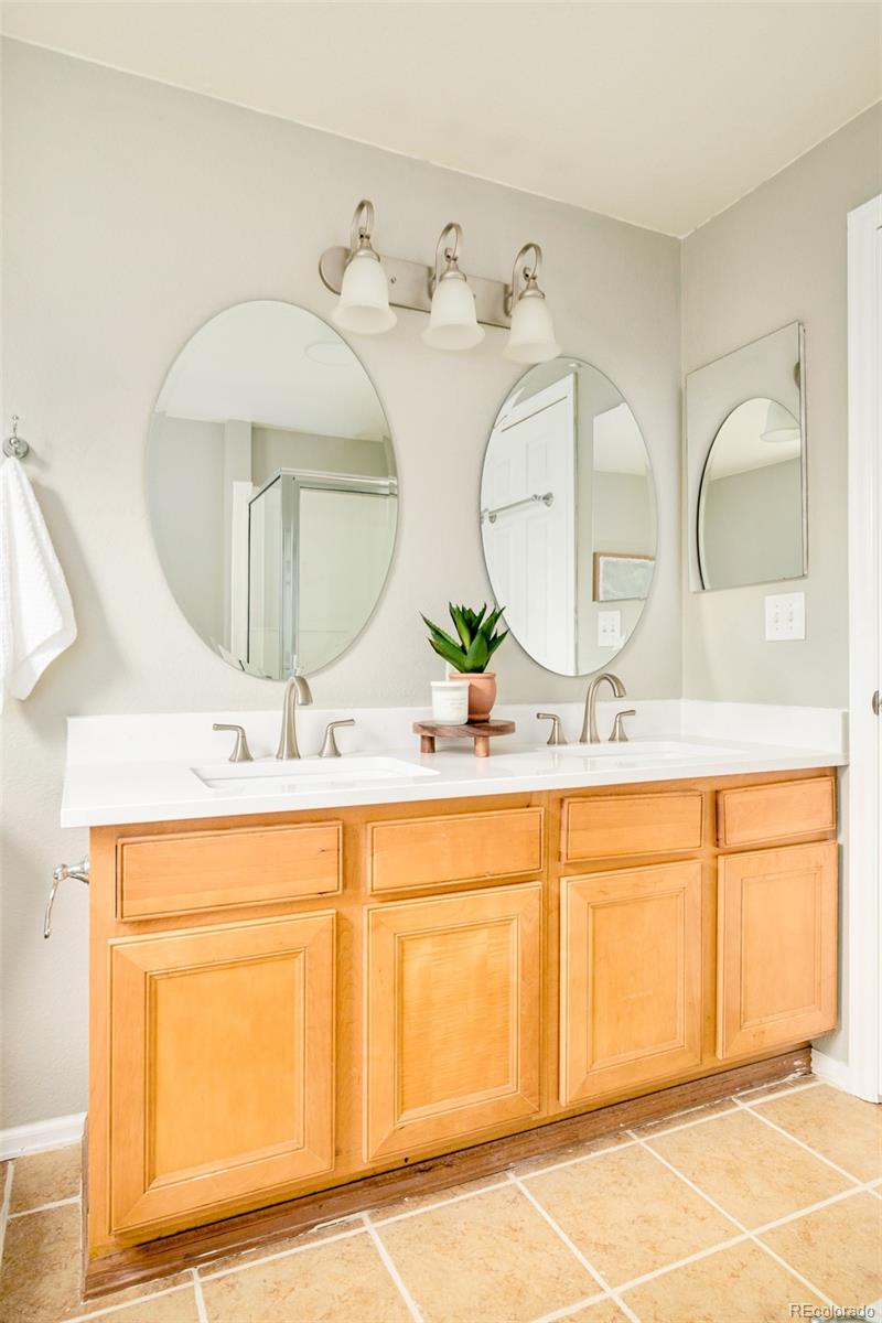 2147 Pinon Circle Erie, CO 80516 - Photo 14 of 34 a bathroom with a double vanity sink and a mirror