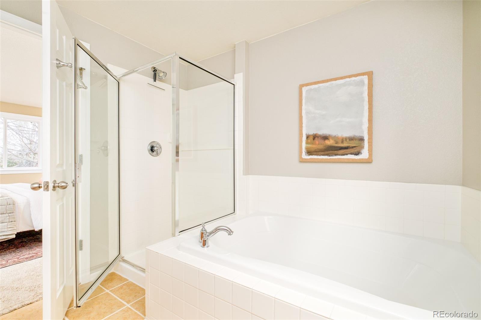 2147 Pinon Circle Erie, CO 80516 - Photo 15 of 34 a bathroom with a bathtub and a shower