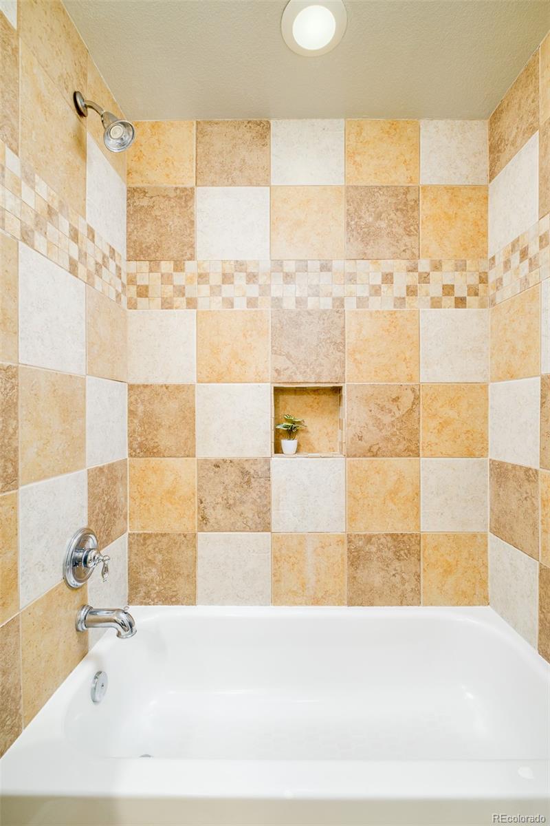 2147 Pinon Circle Erie, CO 80516 - Photo 18 of 34 a bathroom with a bathtub and shower