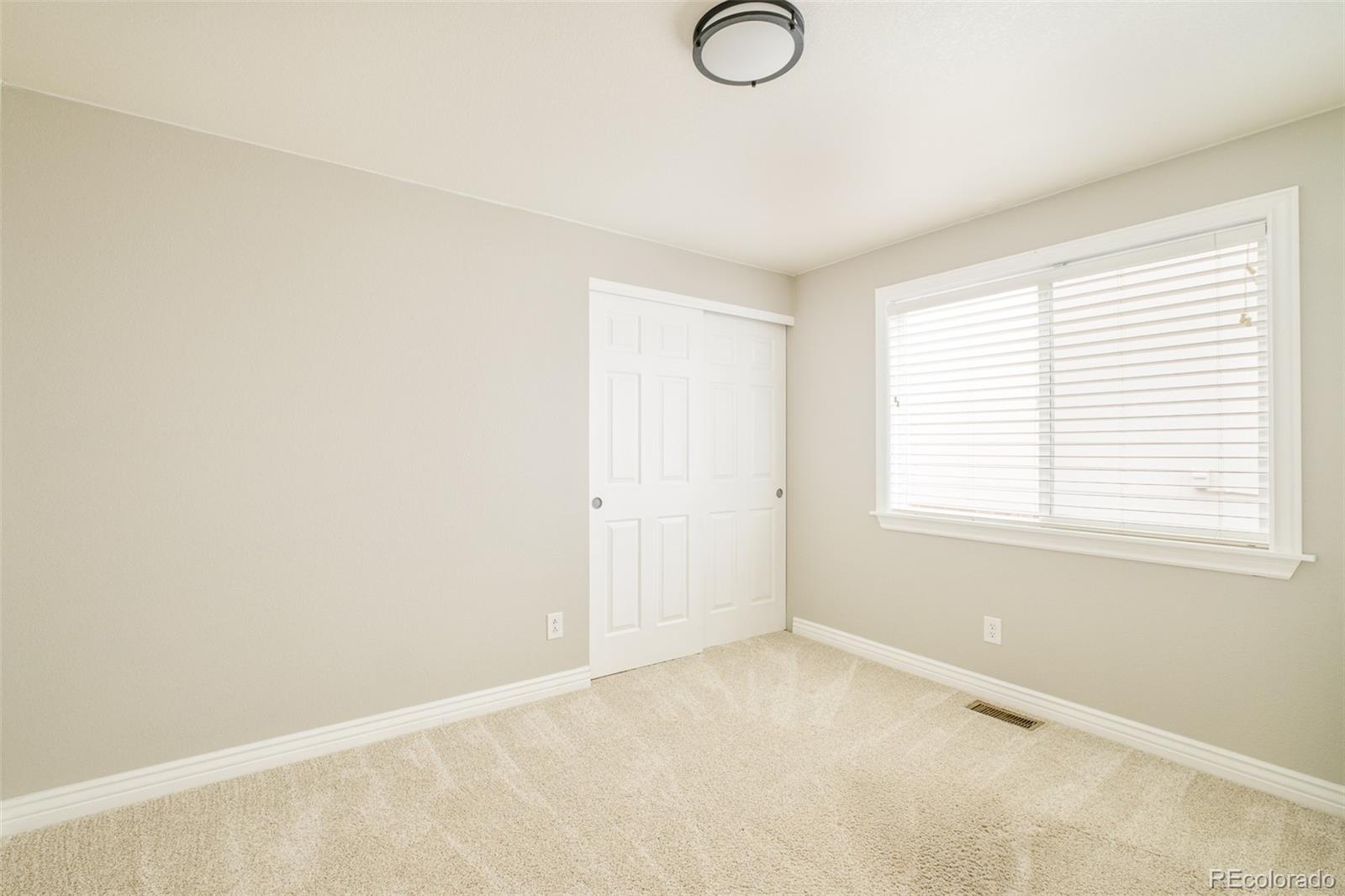 2147 Pinon Circle Erie, CO 80516 - Photo 19 of 34 a view of an empty room with a window