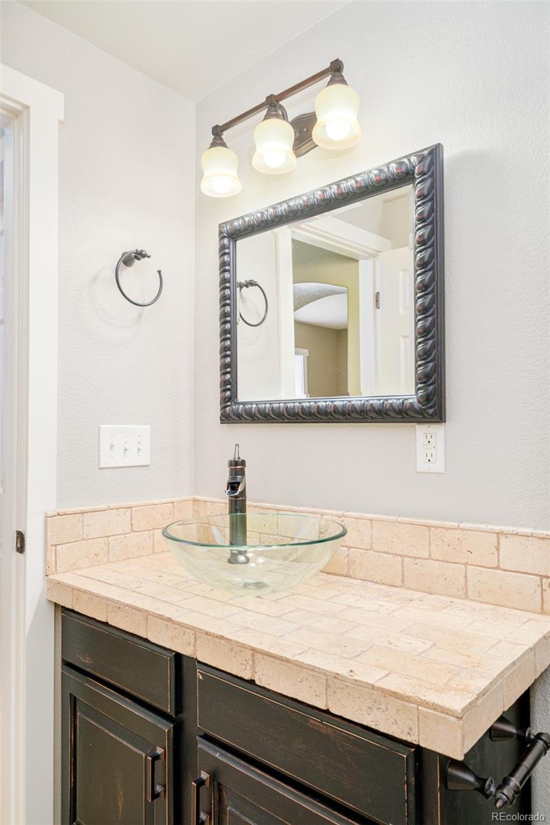 2147 Pinon Circle Erie, CO 80516 - Photo 28 of 34 a bathroom with a sink vanity and a mirror
