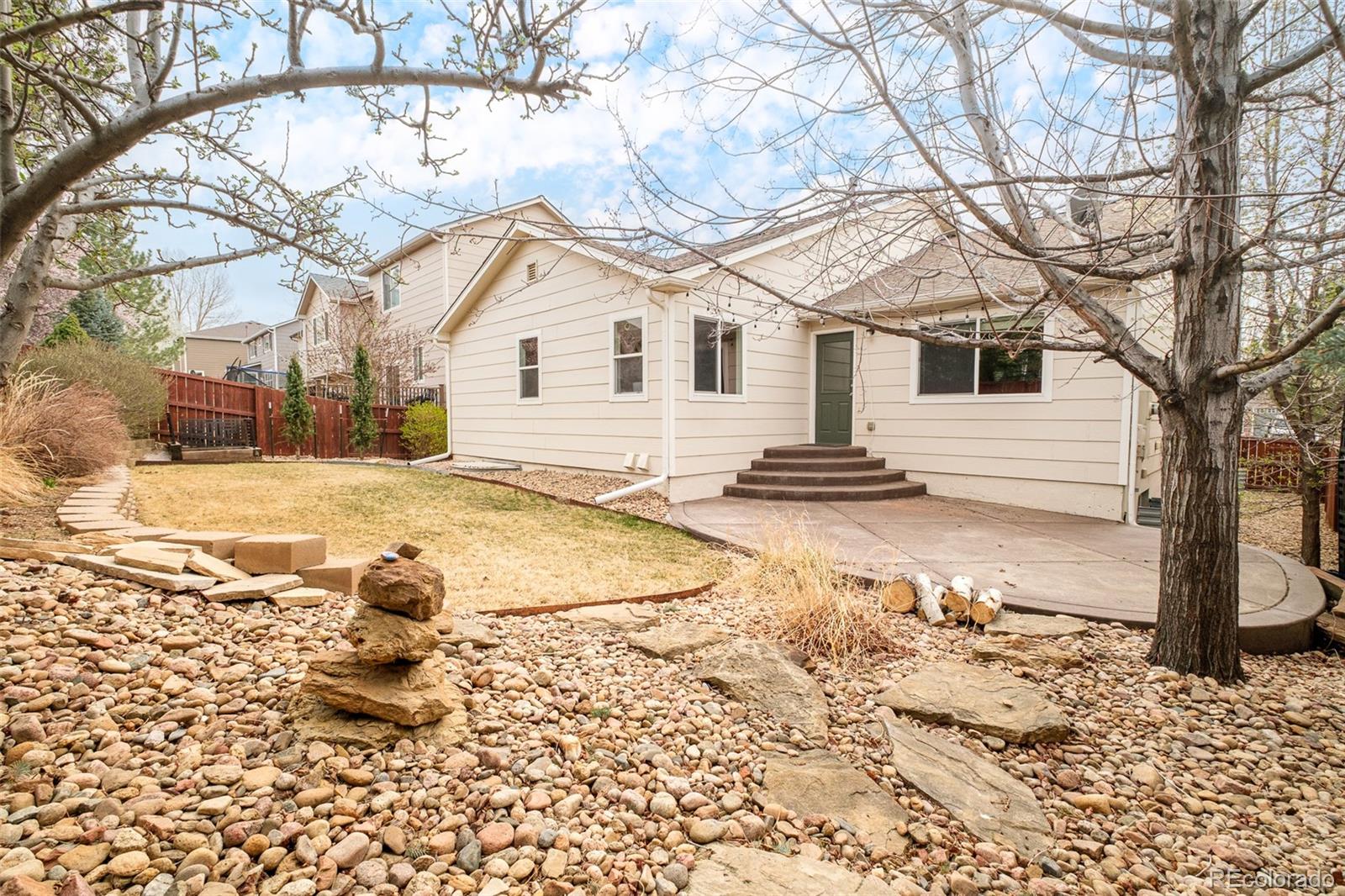 2147 Pinon Circle Erie, CO 80516 - Photo 33 of 34 a view of a white house with a yard covered in snow