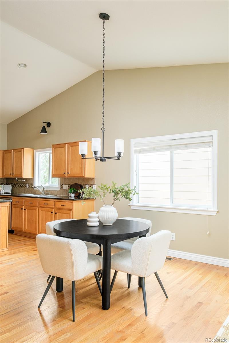 2147 Pinon Circle Erie, CO 80516 - Photo 7 of 34 a dining room with furniture and wooden floor