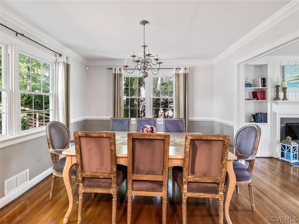 7540 Marilea Road Richmond, VA 23225 - Photo 8 of 35 a dining room with furniture a chandelier and wooden floor