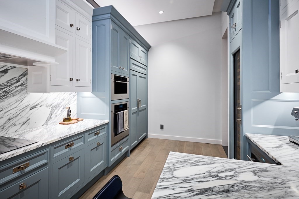 240 Devonshire Street, Unit PH 2B Boston, MA 02110 - Photo 3 of 38 a kitchen with granite countertop cabinets and oven