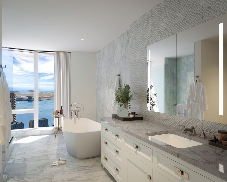 240 Devonshire Street, Unit PH 2B Boston, MA 02110 - Photo 5 of 38 a bathroom with a granite countertop tub sink and mirror