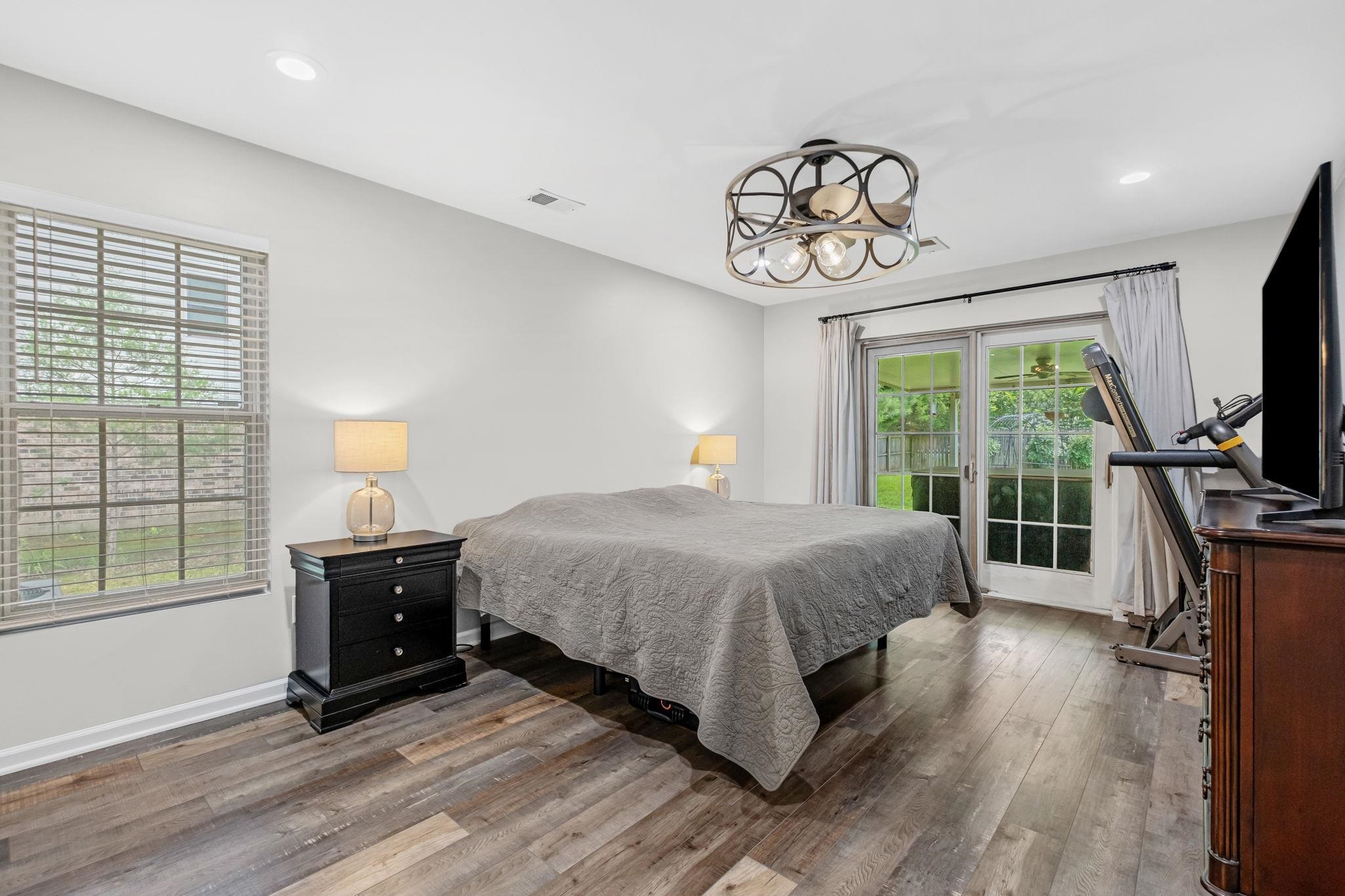 4729 Cedar Ridge Drive Millington, TN 38053 - Photo 17 of 40 Spacious room featuring wood-finish flooring, sliding glass doors to outdoor access, a multi-pane window with blinds, recessed lighting, and an ornate ceiling fan