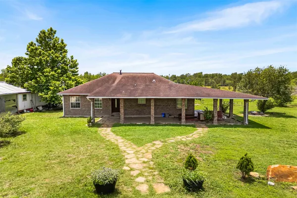 a view of a house with yard and a garden